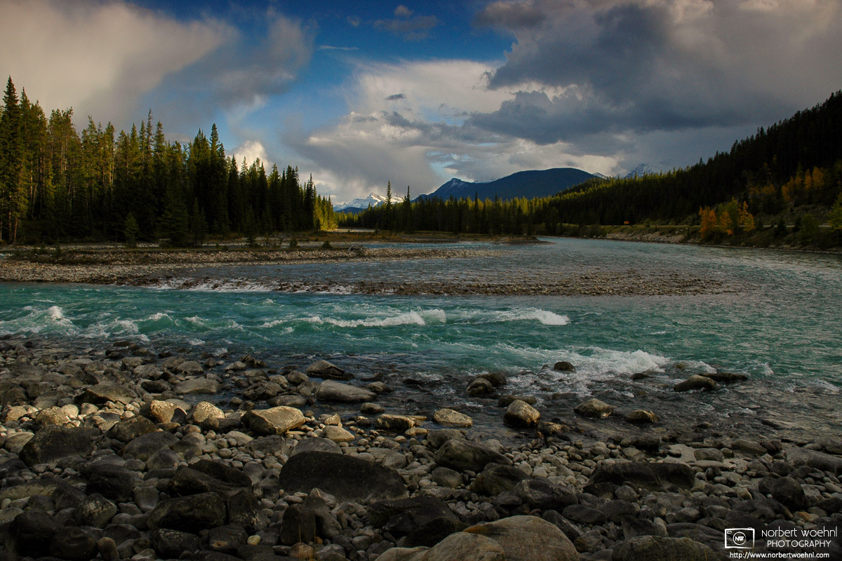 The day's last rays of sunlight hit some rocks along the Athabasca River at Jasper National Park in Alberta, Canada.