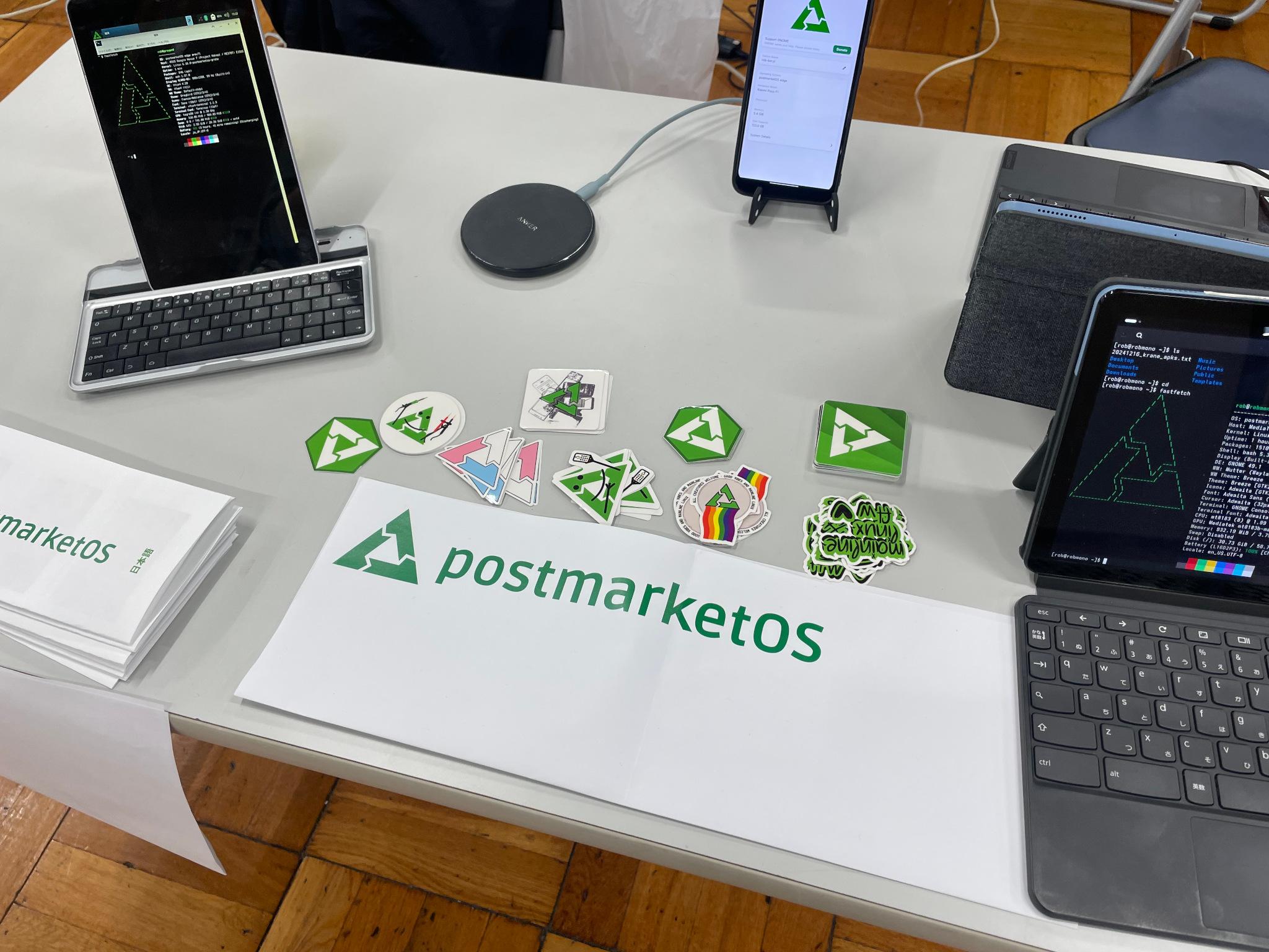 Table with pmOS stickers and devices running pmOS